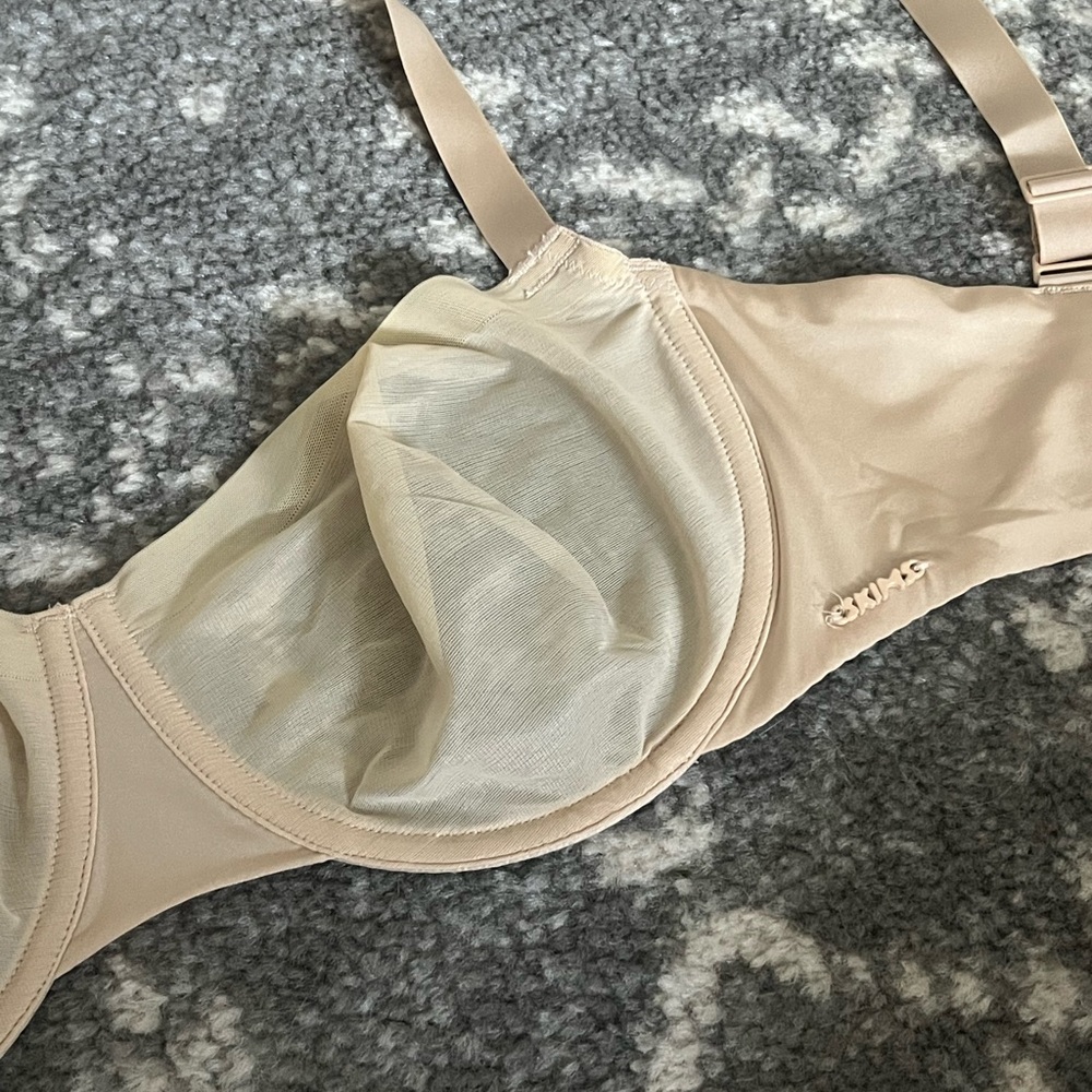 SKIMS tan balconette bra with seamless cups